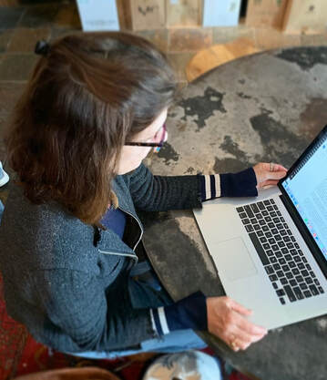 a photograph of a woman at a computer